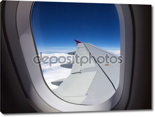 Окно самолета - полет над облаками